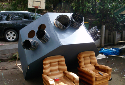 The spaceship structure sits comfortably on a couple of arm chairs.